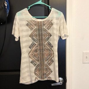 White top with brown detail and open back